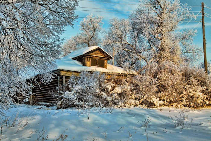 Abandoned house covered in snow during winter
