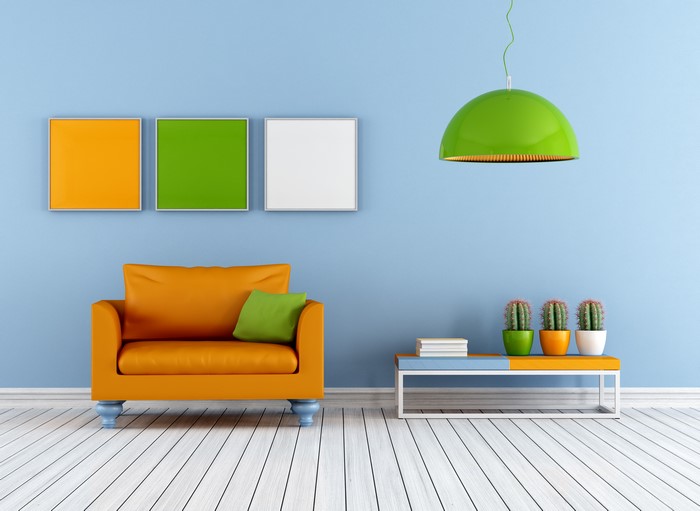 Modern living room with orange armchair and green lamp