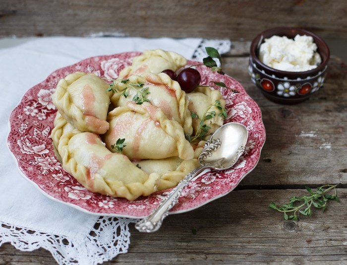 Dumplings with cherries and cottage cheese on a plate