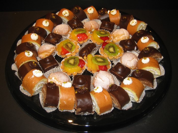 Assortment of small cakes and pastries on a platter