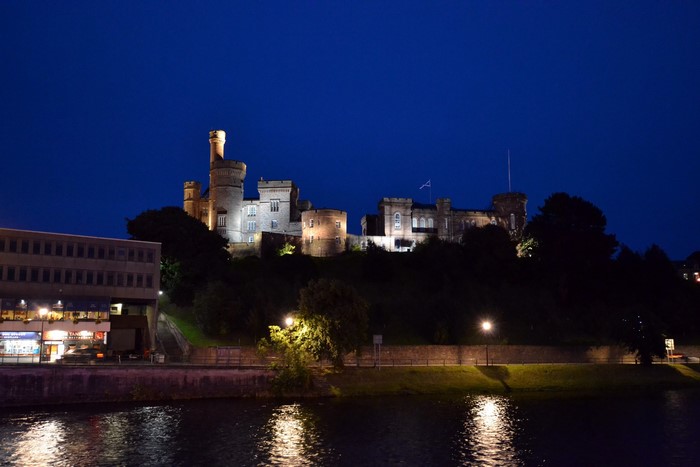 Inverness Castle at night by the river in Scotland