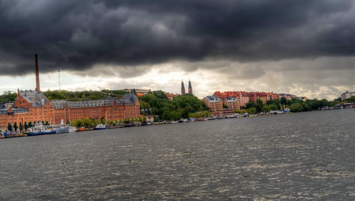 Stockholm waterfront with industrial buildings and stormy clouds
