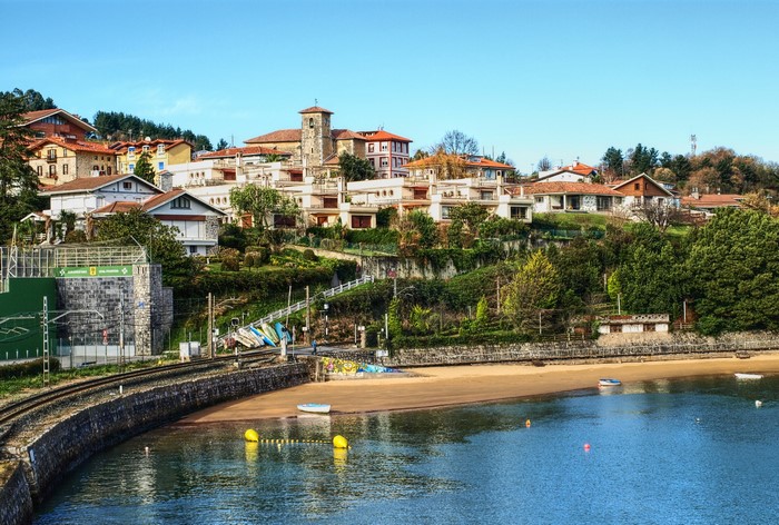 Coastal town with church tower and beach