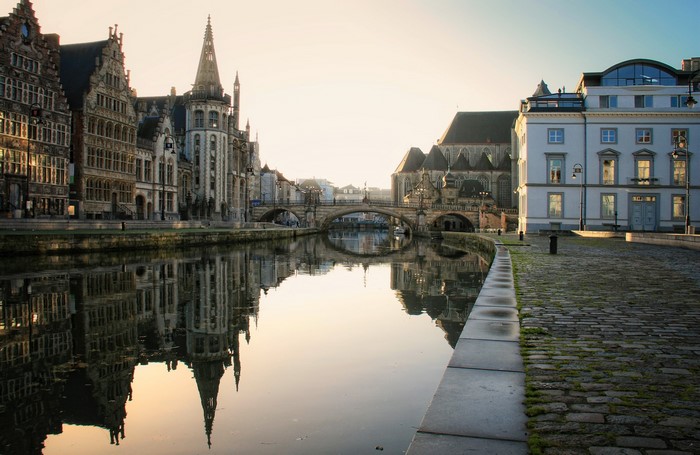 Canal in Ghent, Belgium with historic buildings and bridge