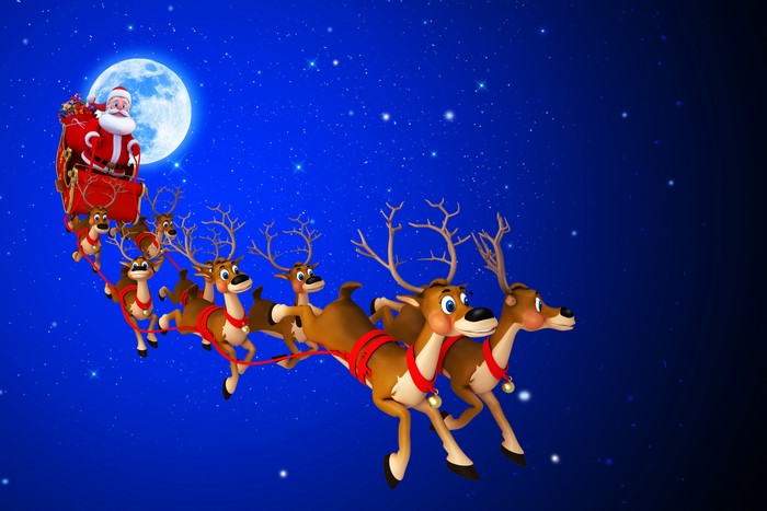 Santa Claus and reindeer flying in the night sky