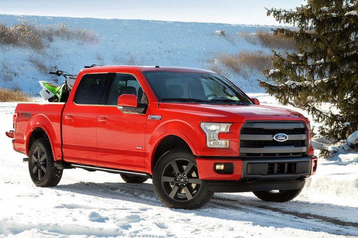 Red Ford F-150 Truck in Snow with Dirt Bike