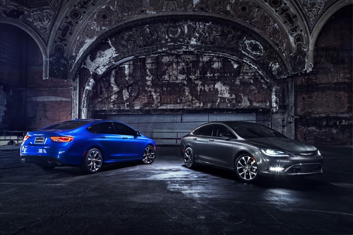 Two Chrysler 200 sedans parked in an abandoned building