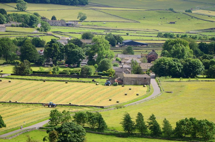 Foolow Village, England with Hay Bales and Tractors