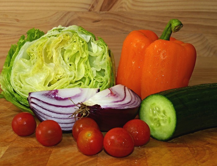 Assortment of fresh vegetables on a wooden cutting board