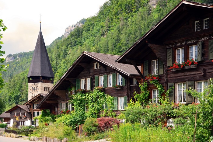 Wooden houses and church tower in Switzerland