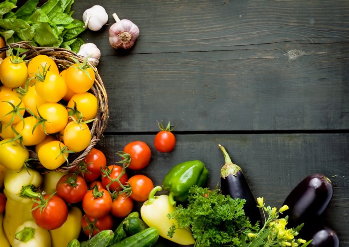 Vegetables and Tomatoes on a Wooden Table
