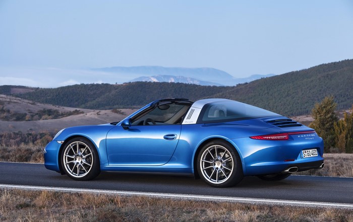 Blue Porsche 911 Targa 4 driving on a road
