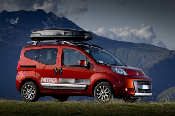 Red Fiat Qubo with roof box in mountains