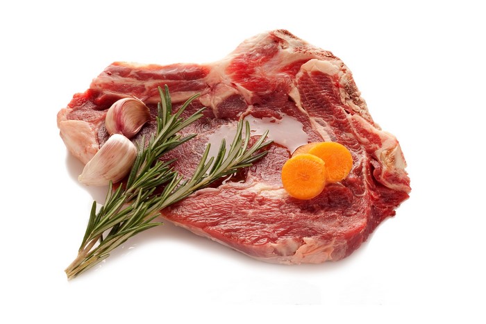 Raw meat with rosemary, garlic, and carrots