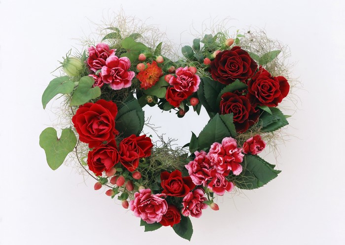 Heart-shaped floral arrangement with roses and carnations