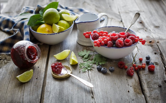 Berries, Limes, and Jam on a Wooden Table