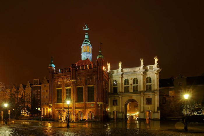Gdańsk at night with street lights and historic buildings