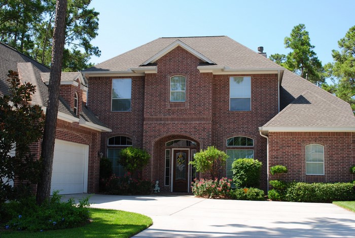 Brick house with garage and manicured lawn