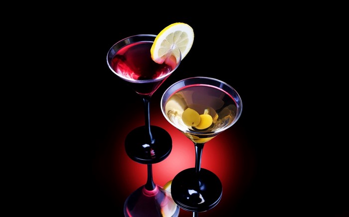 Two cocktails with lemon and olives