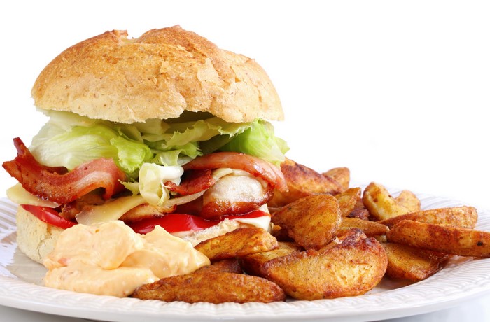 Hamburger with bacon, lettuce, cheese, and fries