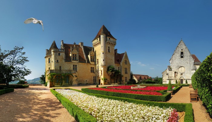 Chateau des Milandes castle with formal gardens and owl