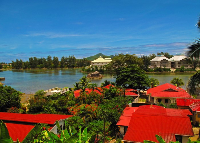 Tropical island with red-roofed houses and a bay