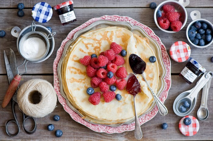 Pancakes with raspberries, blueberries, and jam