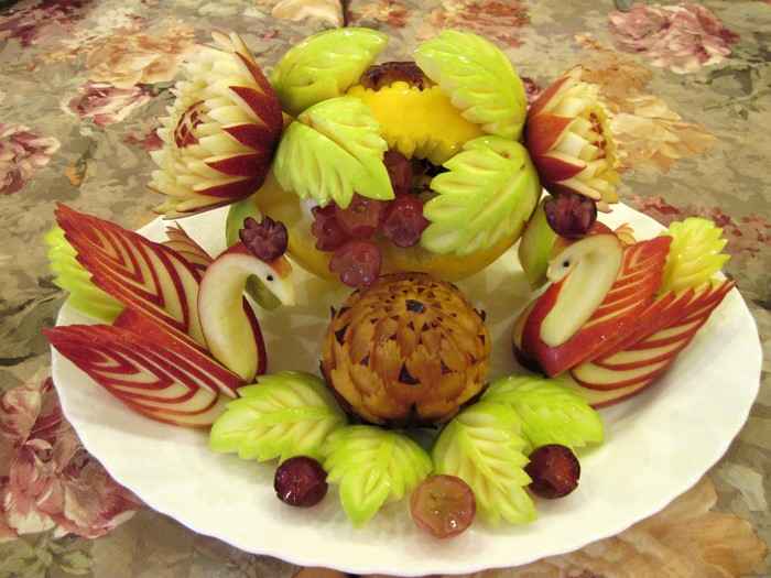 Fruit carving of swans and flowers
