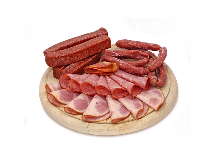 Assortment of cured meats on a wooden board