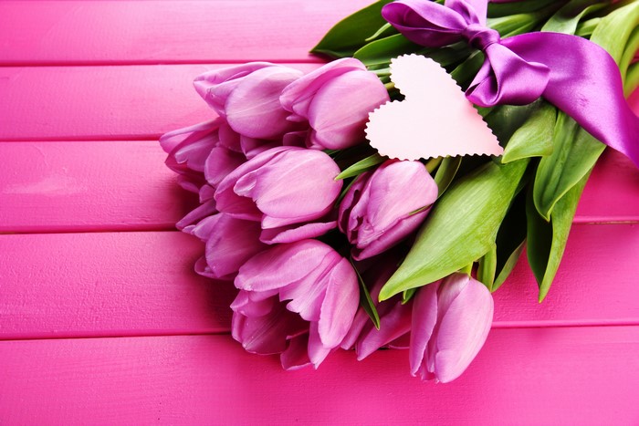 Bouquet of purple tulips with a heart tag and ribbon