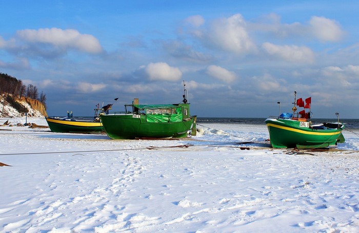 Fishing boats on a snowy coast in Poland