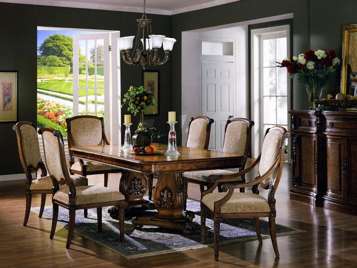 Dining room with table, chairs, chandelier, and doors