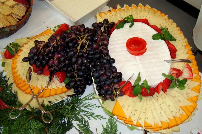 Cheese and fruit platter with crackers and dip