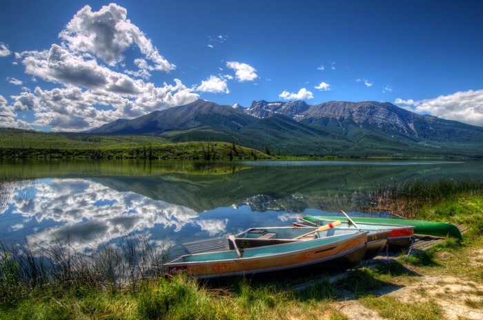 Boats on a lake with mountains in Jasper National Park, Canada