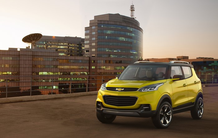 Yellow Chevrolet Adra Concept Car in front of Modern Buildings