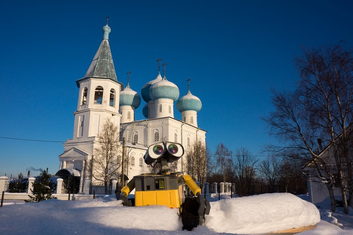 WALL-E robot in front of a snow-covered church