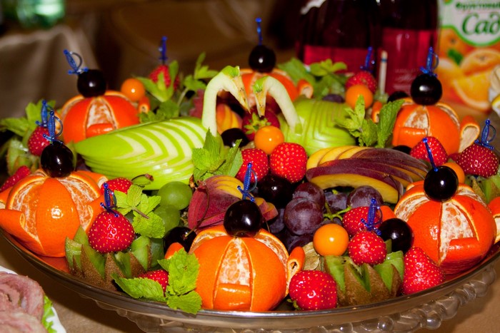 Fruit platter with carved apples and mandarins