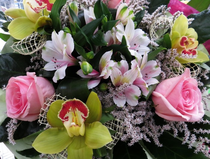 Pink roses, alstroemeria, and orchids in a bouquet