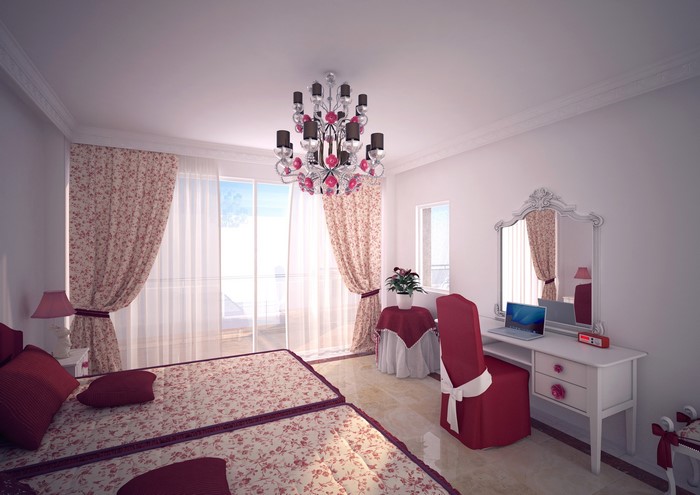 Bedroom with two beds, chandelier, and vanity