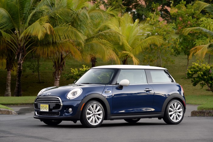 Blue Mini Cooper F56 parked outdoors with palm trees