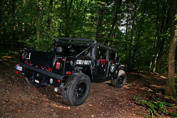 Black Hummer H1 with Call of Duty theme in forest