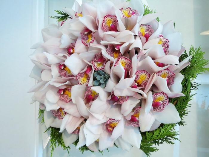 Bouquet of white orchids with green foliage