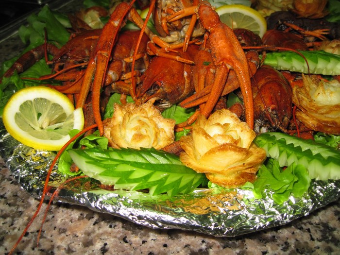 Seafood platter with crayfish, lemon, and cucumber garnish