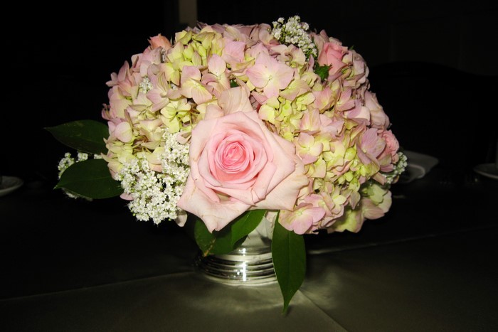 Pink rose and hydrangea floral arrangement in silver vase