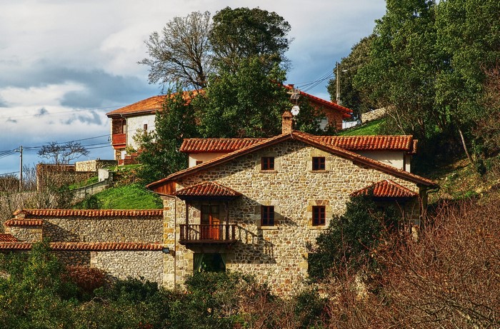 Stone houses with red tile roofs in Kantabria, Spain