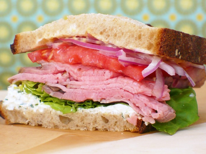 Roast beef sandwich with lettuce, tomato, and onion