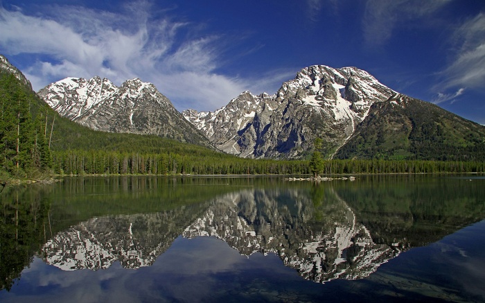 Snow-capped mountains reflected in a calm lake
