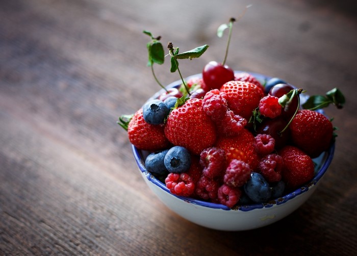 Bowl of fresh strawberries, raspberries, and blueberries