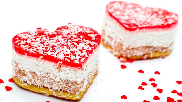 Two heart-shaped cakes with red jelly and coconut