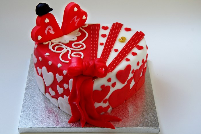 Heart-shaped cake with red and white decorations